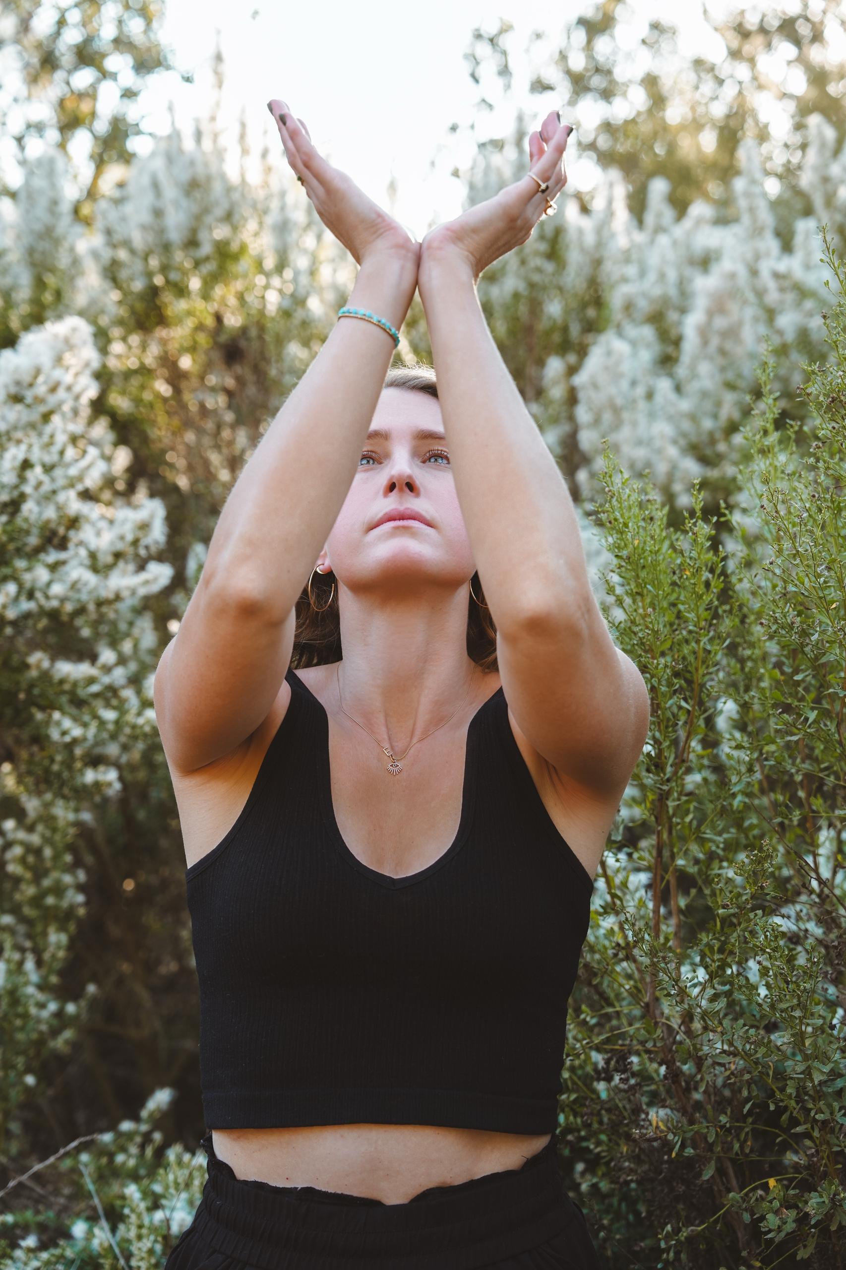 Emily practicing qigong, arms raised